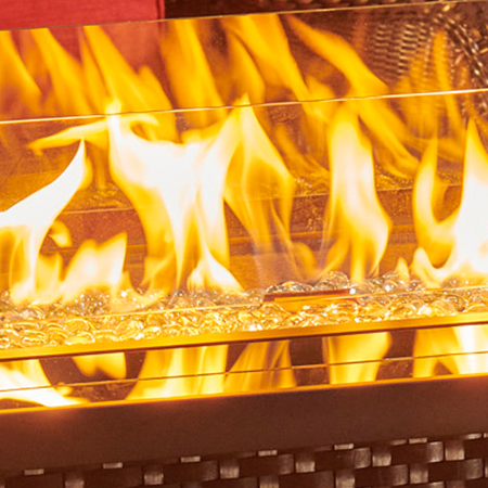 The Outdoor Greatroom Company closeup shot of their Crystal Fire Burner with flames