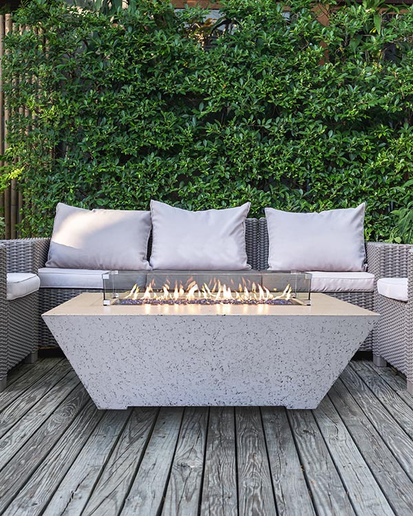 Olympus fire pit table by Grand Canyon in a lifestyle seting sitting on a deck