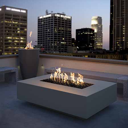 The outdoor Plus Cabo Linear Natural Gas Fire Pit in a modern city rooftop lifestyle