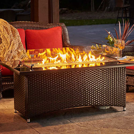 Montego Gas Fire Table by The Outdoor GreatRoom Company at dawn on a patio