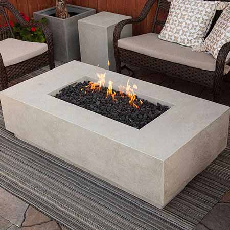 Prism Hardscapes Tavola 8 Natural Gas Fire Pit in a lifestyle setting